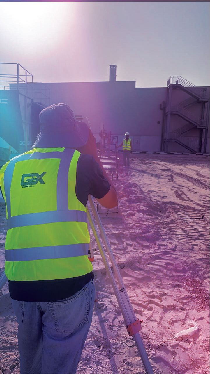 GeoX surveyors working together to take measurements across a construction site.